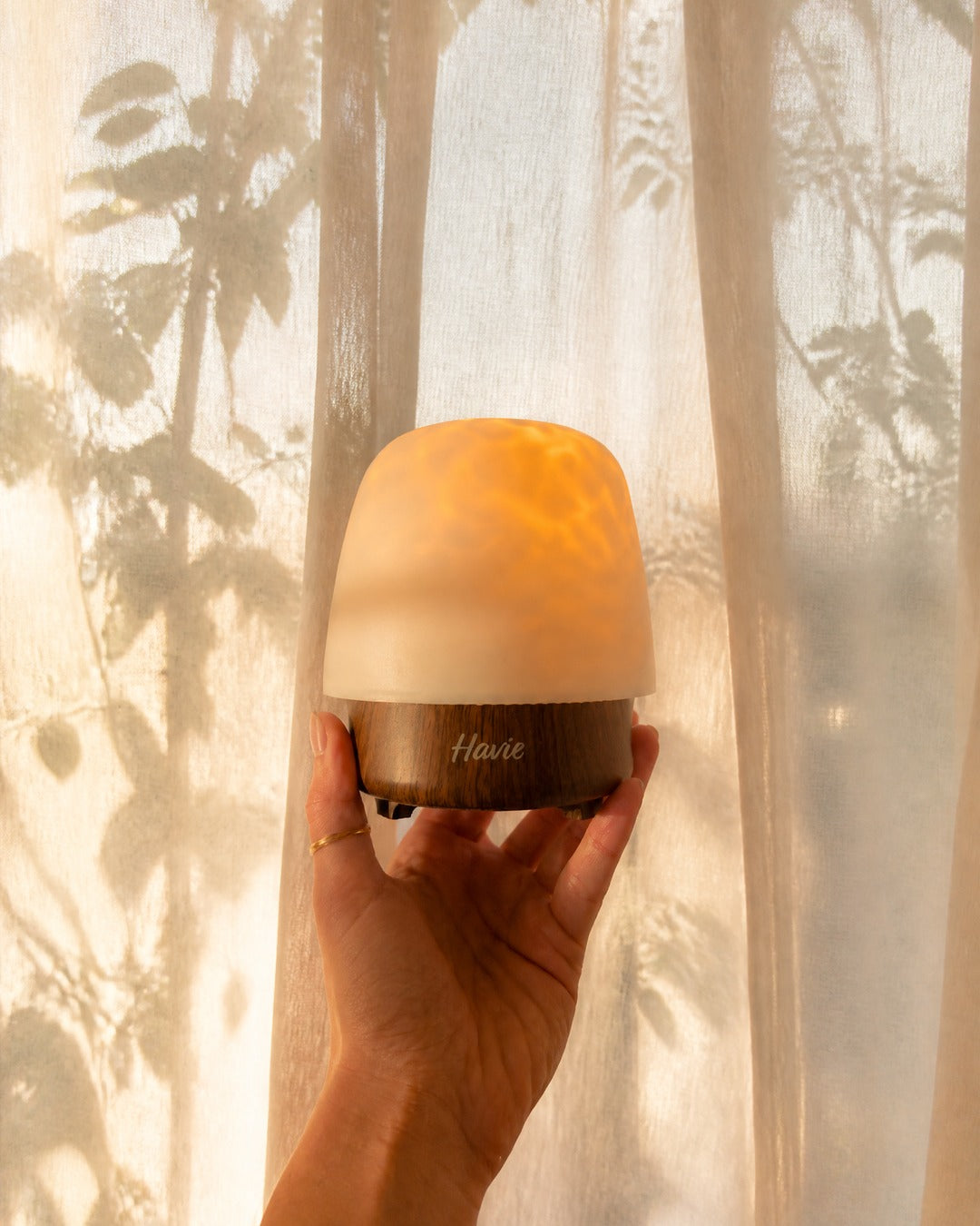Havie lamp glowing in a cozy bedroom